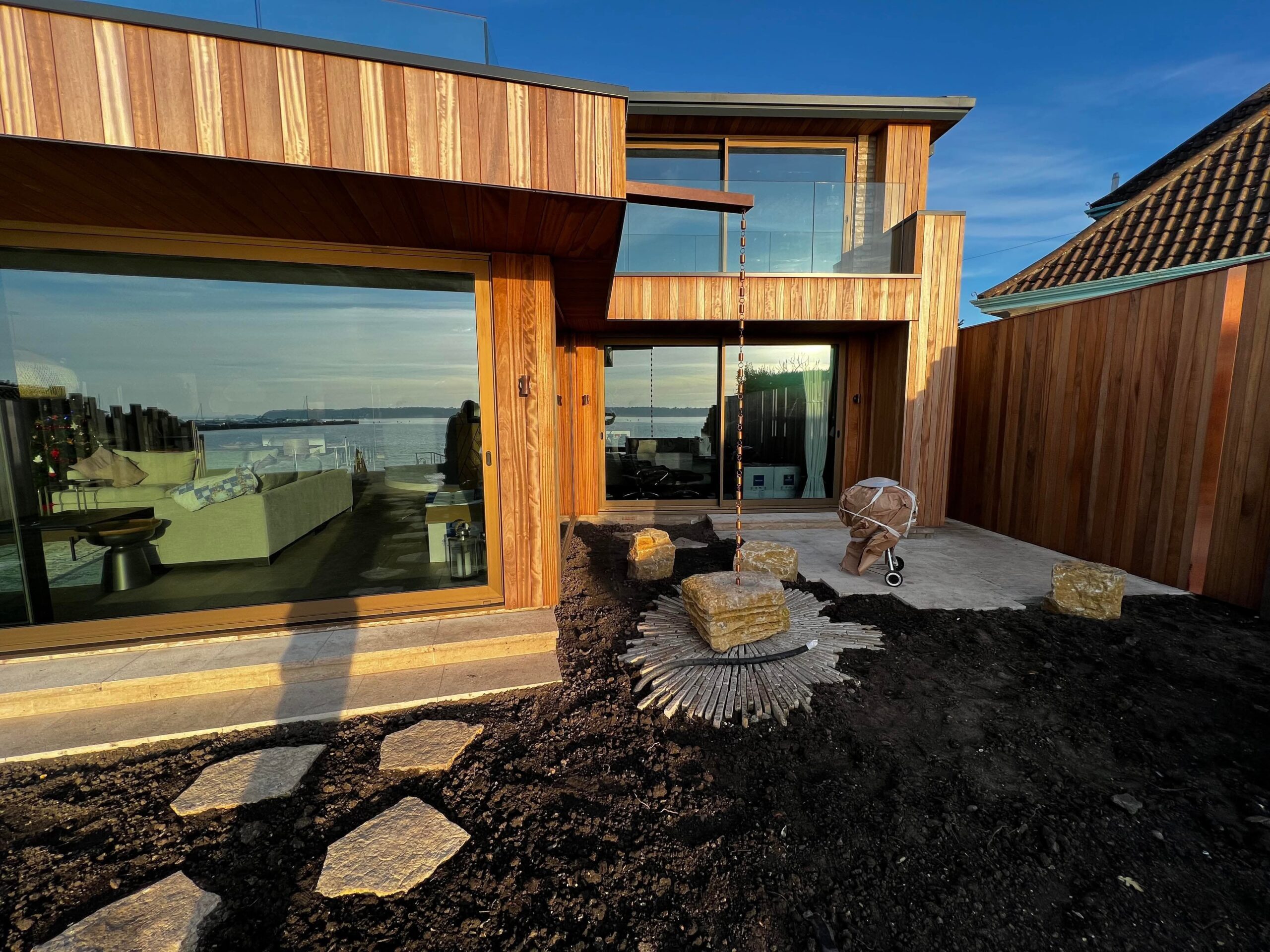 A new build building made with timber construction, featuring an outside landscaped area.